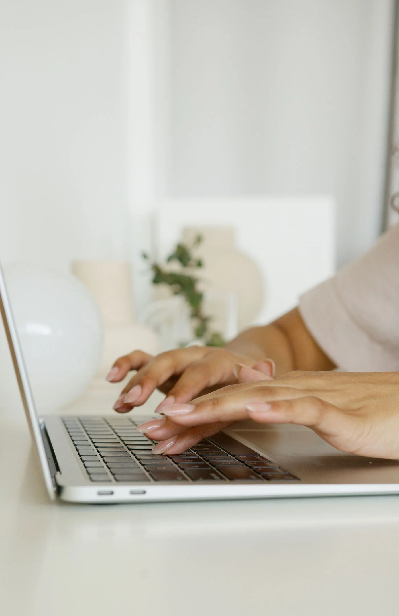 Hände tippen auf einer Laptoptastatur